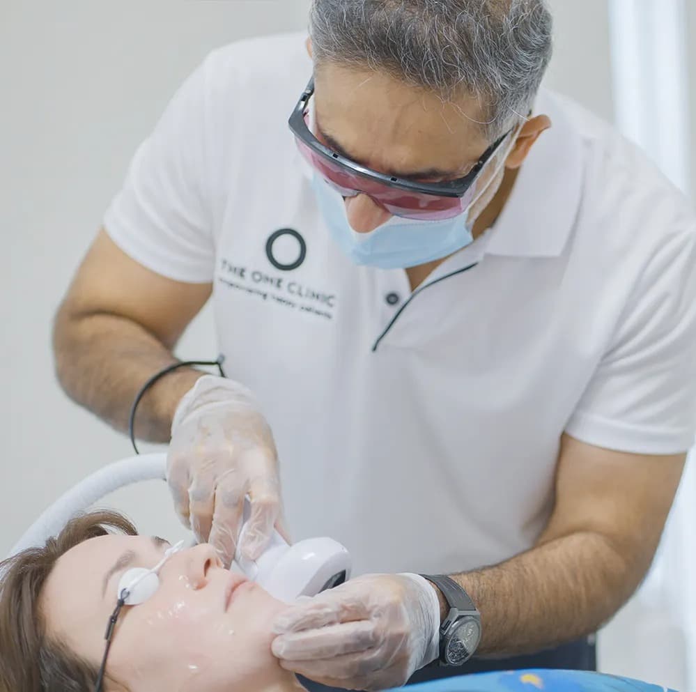 Skin specialist examining patient at The One Clinic